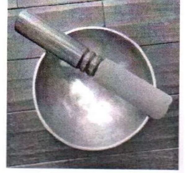 A grey photograph of a hemispherical singing bowl with a cylindrical mallet resting across it.